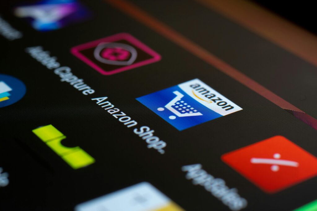 Amazon Ads Close-up of the Amazon shopping app icon on a smartphone screen. Ideal for online shopping and technology themes.